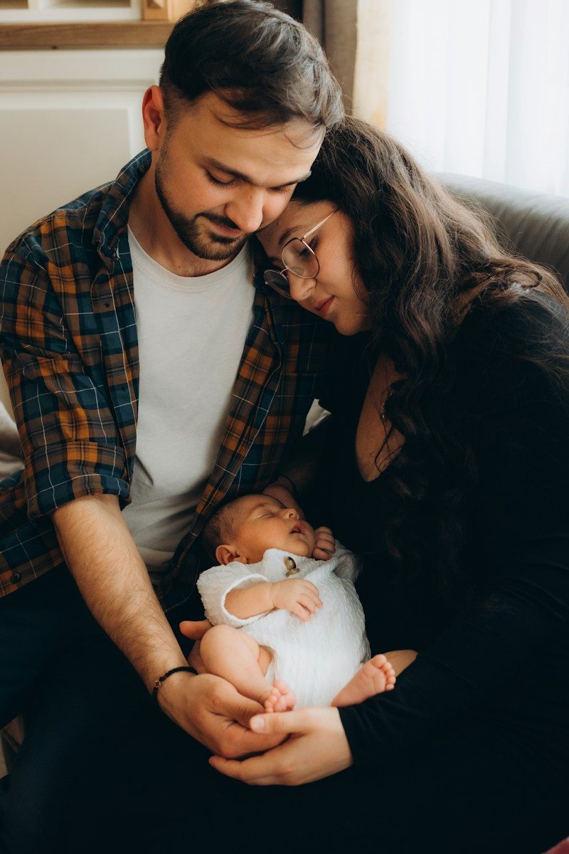 A loving couple holding their newborn baby